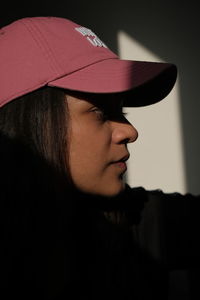 Close-up portrait of woman wearing hat