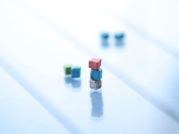 Close-up of painted cube shaped rocks on table