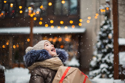 Cute girl holding gift box outdoors