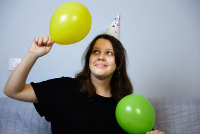 Children have fun playing, blowing up colorful balloons, at a birthday party