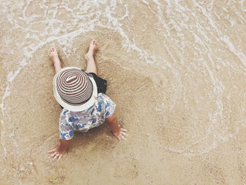 High angle view of child on sand at beach
