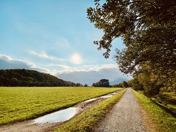 Empty road along countryside landscape