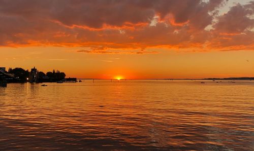 Scenic view of sea against orange sky