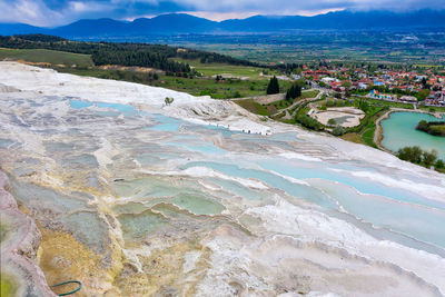 High angle view of land and sea against sky