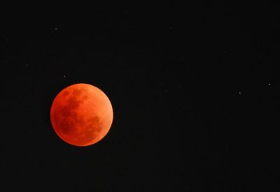 Low angle view of moon against clear sky at night