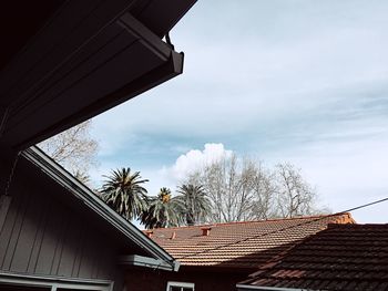 Low angle view of houses against cloudy sky