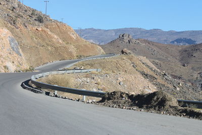 Scenic view of mountain road against clear sky