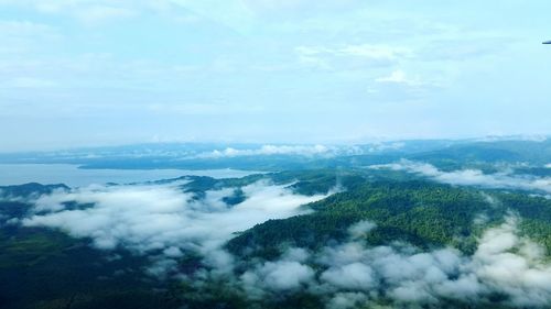 Scenic view of green mountains against sky