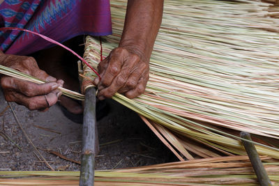 Man weaving straw at workshop