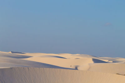 Scenic view of desert against clear blue sky