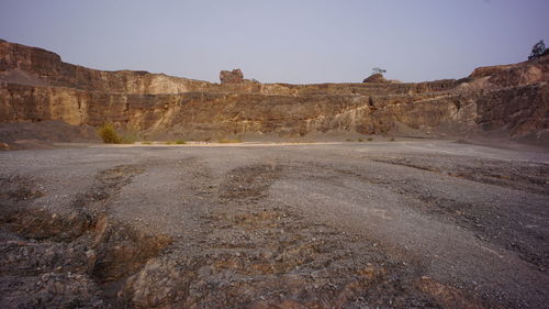 Rock formations on landscape against clear sky