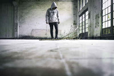 Rear view of man standing on footpath