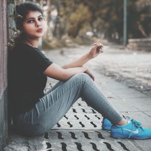 Portrait of young woman sitting outdoors