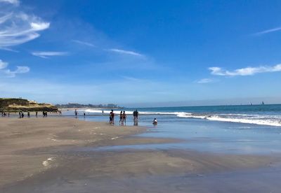 People on beach against sky