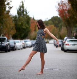 Full length of woman on road in city