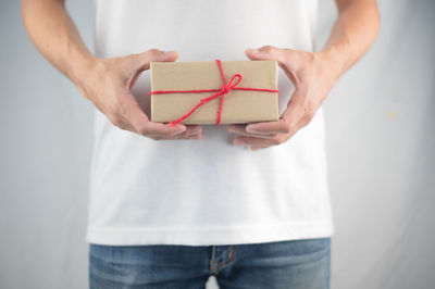 Midsection of woman holding camera in box