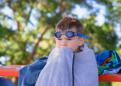 Close-up of boy wrapped in towel