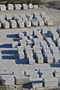 High angle view of empty chairs on sand