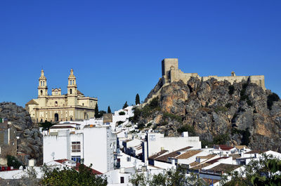 Low angle view of temple against clear blue sky