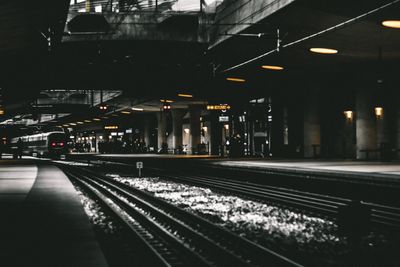 Railway tracks at railroad station at night