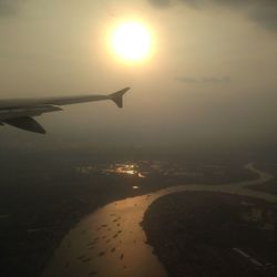 Cropped image of airplane flying over sea