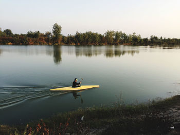 Man kayaking in lake