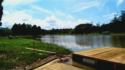 Pier by lake against sky