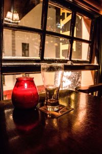 Close-up of red wine glass on table