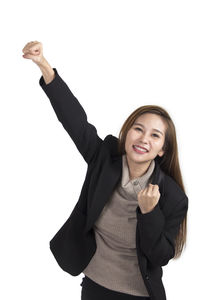 Portrait of a smiling young woman against white background
