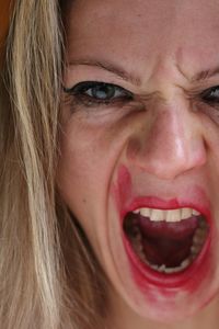 Close-up portrait of mid adult woman screaming