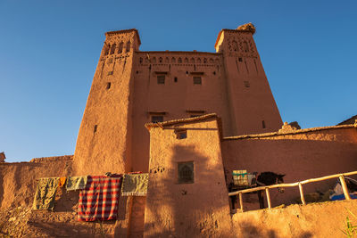 Low angle view of castle against clear blue sky