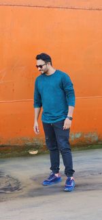 Low section of man standing on beach