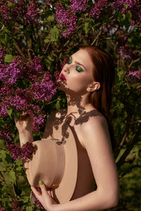 Midsection of woman with pink flower