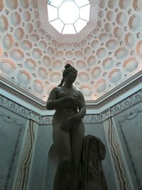 Low angle view of statue against ceiling