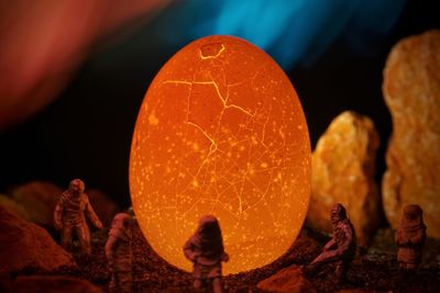 Close-up of illuminated lantern on rock at night