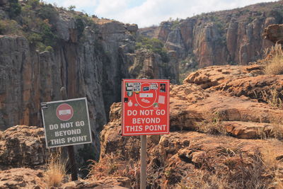 Sign board on rock formations