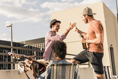 Three friends having a rooftop party