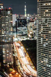 High angle view of illuminated buildings in city at night