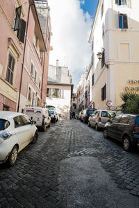 Cars on street amidst buildings in city