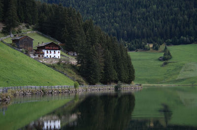 Scenic view of lake by trees and buildings