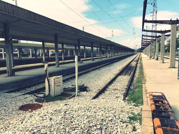 Train at railroad station against sky