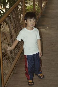 Full length of boy standing on walkway