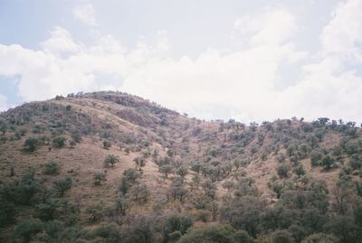 Scenic view of mountains against cloudy sky