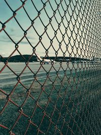 Full frame shot of chainlink fence against sky