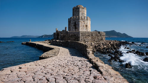 Bourtzi of methoni castle, scenic view of sea against clear blue sky