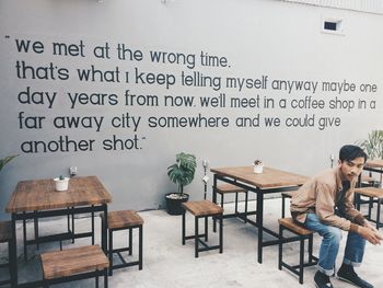 Man and woman sitting on table