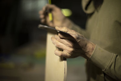 Carpenter holds board. details of woodwork. joinery. work on assembly of furniture.