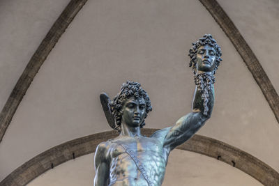 Low angle view of angel statue against historic building