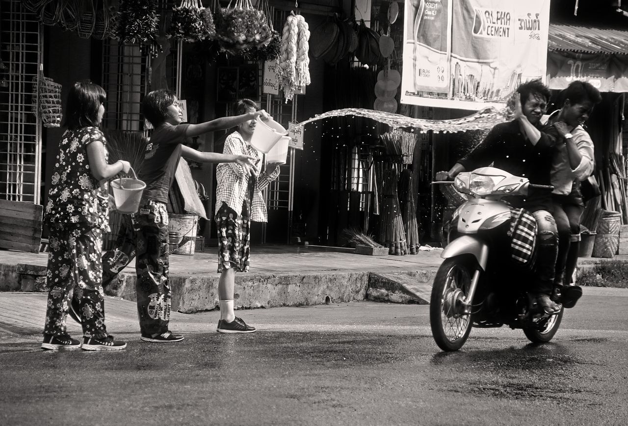 PEOPLE WITH UMBRELLA ON STREET