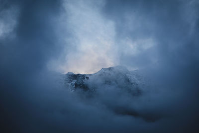 Low angle view of volcanic mountain against sky